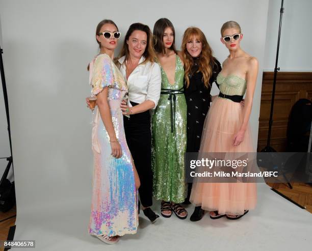 Designer Alice Temperley and Charlotte Tilbury pose with models backstage following the Temperley London show during London Fashion Week September...