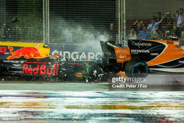 Max Verstappen of Red Bull Racing and The Netherlands crashes into Fernando Alonso of McLaren and Spain during the Formula One Grand Prix of...