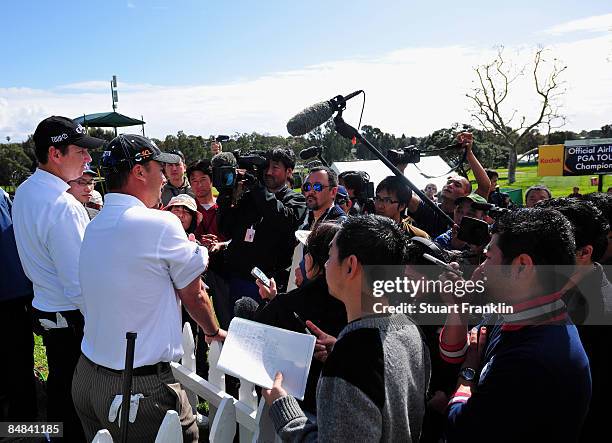 Chris Di Marco and J.J. Henry answer questions from Japanese media after playing a few holes with the teenage Ryo Ishikawa of Japan after the...