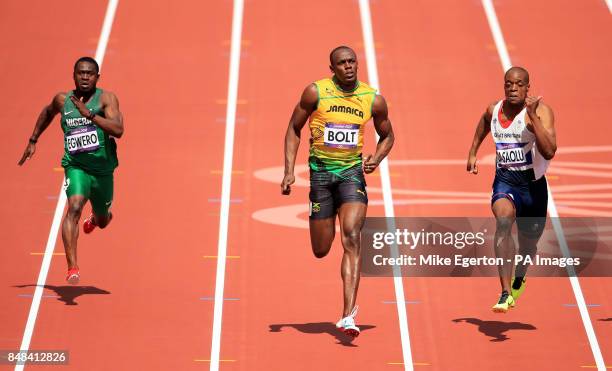 Jamaica's Usain Bolt runs next to Great Britain's James Dasaolu and Nigeria's Ogho-Oghene Egwero in the Men's 100m Heats during day eight of the...