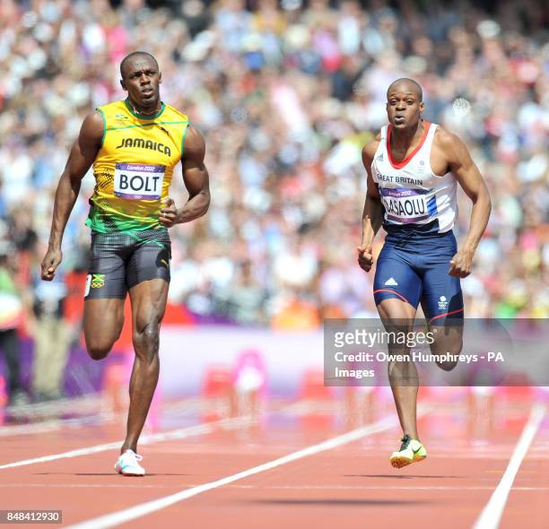 Jamaica's Usain Bolt in action with Great Britain's James Dasaolu in a heat of the Men's 100m at The Olympic Stadium, London.