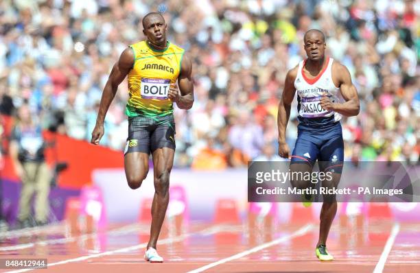 Jamaica's Usain Bolt in action with Great Britain's James Dasaolu in a heat of the Men's 100m at The Olympic Stadium, London.