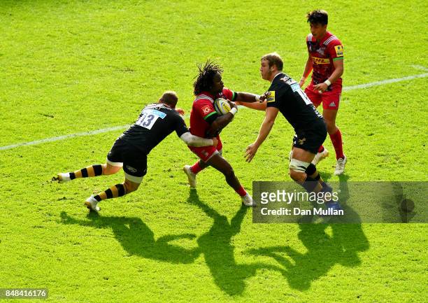 Marland Yarde of Harlequins is tackled by Elliot Daly and Joe Launchbury of Wasps during the Aviva Premiership match between Wasps and Harlequins at...