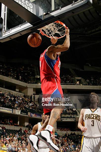 Andres Iguodala of the Philadelphia 76ers jams over Troy Murphy of the Indiana Pacers at Conseco Fieldhouse on February 17, 2009 in Indianapolis,...