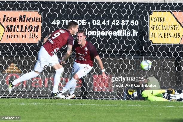 Metz's French forward Nolan Roux reacts after scoring Angers' French goalkeeper Alexandre Letellier during the French L1 football match between...