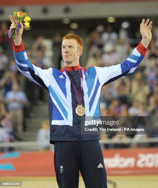 Great Britain's Ed Clancy celebrates with his Bronze medal on the podium after the Men's Omnium event at the Velodrome in the Olympic Park, during...