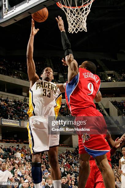 Danny Granger of the Indiana Pacers shoots over Andre Iguodala of the Philadelphia 76ers at Conseco Fieldhouse on February 17, 2009 in Indianapolis,...