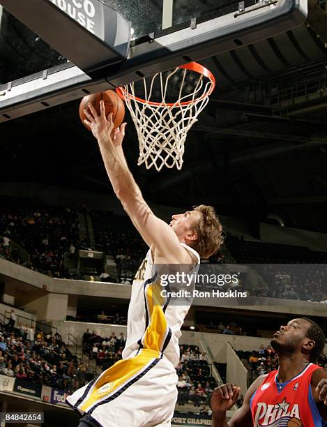 Troy Murphy of the Indiana Pacers lays the ball up over Samuel Dalembert of the Philadelphia 76ers at Conseco Fieldhouse on February 17, 2009 in...