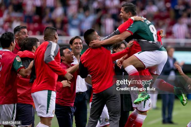 Jesus Godinez of Chivas celebrates with teammates after scoring the first goal of his team during the 9th round match between Chivas and Pumas UNAM...