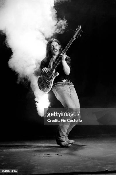Photo of MOTORHEAD and LEMMY; Lemmy, posed, studio, with firework attached to bass,