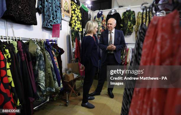 Liberal Democrat leader Sir Vince Cable chats with Claire Alexander, co-owner of Carry On Clothing in the exhibition hall, during the second day of...