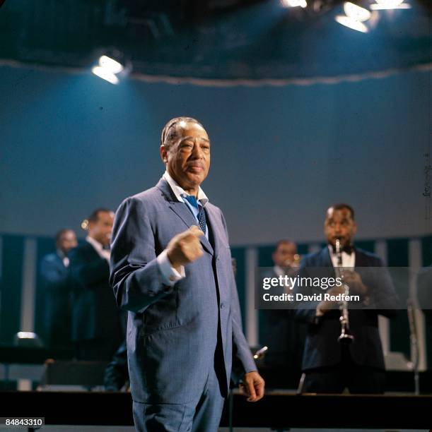 American composer, pianist and bandleader Duke Ellington performs on stage, with clarinetist Jimmy Hamilton behind, during recording of the BBC...