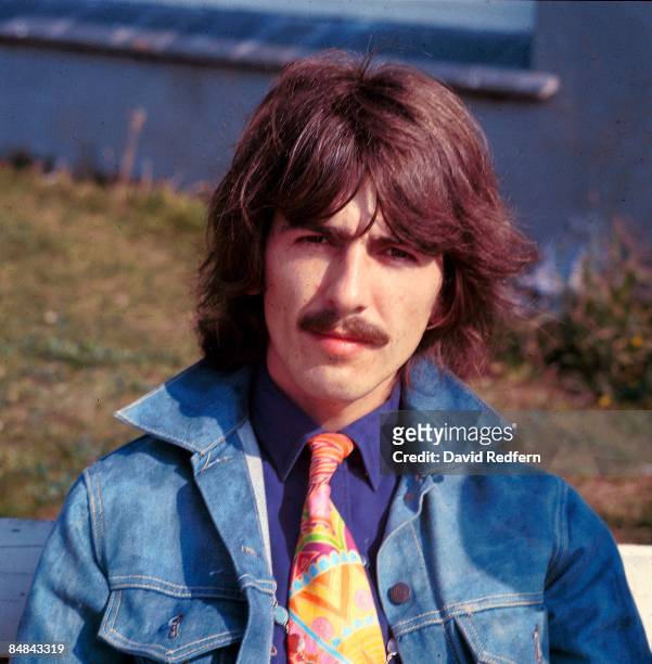 George Harrison of English rock and pop group The Beatles, wearing a denim jacket, takes part in filming of the television musical film 'Magical...