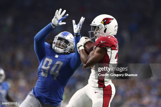 David Johnson of the Arizona Cardinals makes a catch behind Ezekiel Ansah of the Detroit Lions at Ford Field on September 10, 2017 in Detroit,...