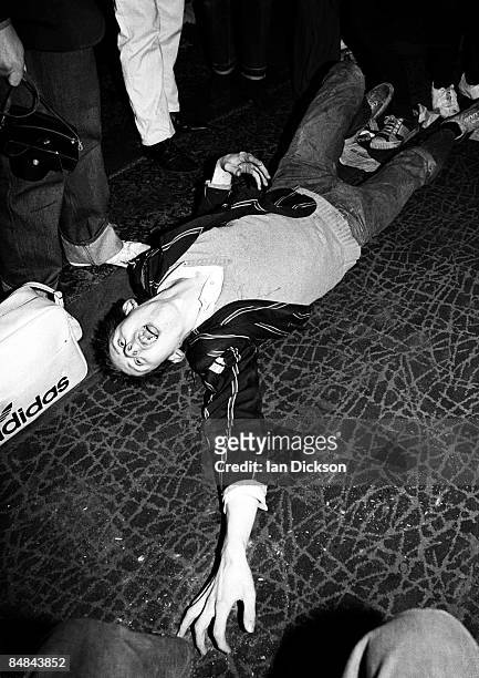 Shane MacGowan lies on the floor of the Harlesden Coliseum at a punk gig, London, 11 March 1977.