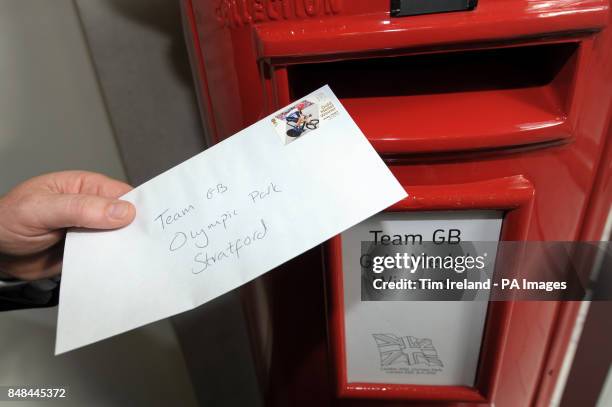 Veteran postman, Doug Mowatt, delivers a letter with a Royal Mail stamp commemorating Great Britain's Gold Medal winner to the Royal Mail office in...