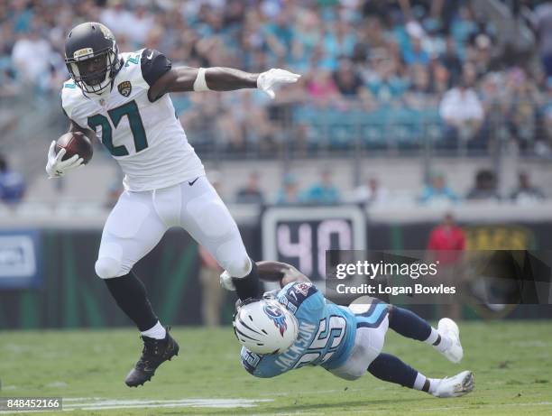 Leonard Fournette of the Jacksonville Jaguars is tackled by Adoree' Jackson of the Tennessee Titans during the first half of their game at EverBank...