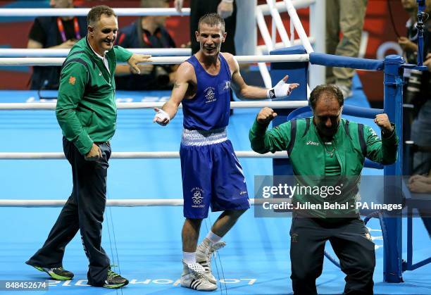 Ireland's John Joe Nevin celebrates with coaches Billy Walsh and Zaur Anita after winning his bout with with Cuba's Lazaro Alvarez Estrada in their...