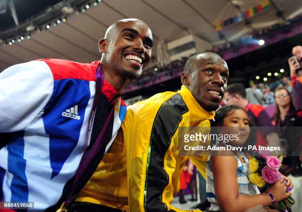Great Britain Mo Farah and his daughter Rihanna celebrates with Usain Bolt medal after victory in the Men's 5000m final on day fifteen of the London...