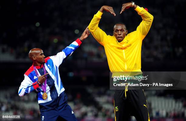 Great Britain Mo Farah celebrates with Usain Bolt victory in the Men's 5000m final on day fifteen of the London Olympic Games in the Olympic Stadium,...