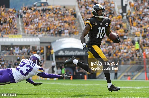 Martavis Bryant of the Pittsburgh Steelers avoid a tackle by Terence Newman of the Minnesota Vikings as he heads to the end zone for a 27 yard...