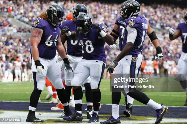 Running back Terrance West of the Baltimore Ravens celebrates his touchdown against the Cleveland Browns in the first quarter at M&T Bank Stadium on...