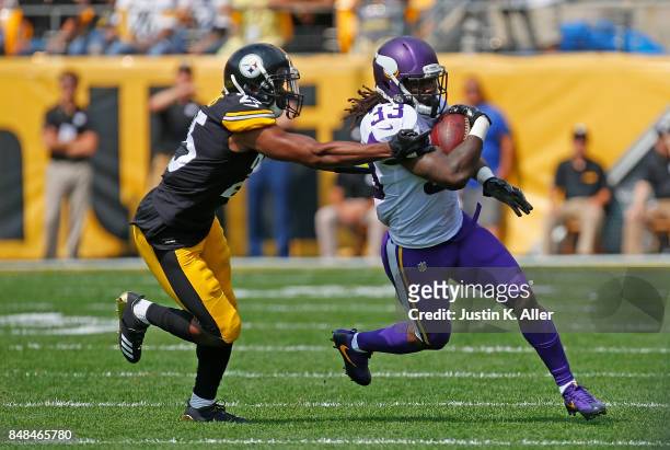 Dalvin Cook of the Minnesota Vikings rushes against Artie Burns of the Pittsburgh Steelers in the first quarter during the game at Heinz Field on...