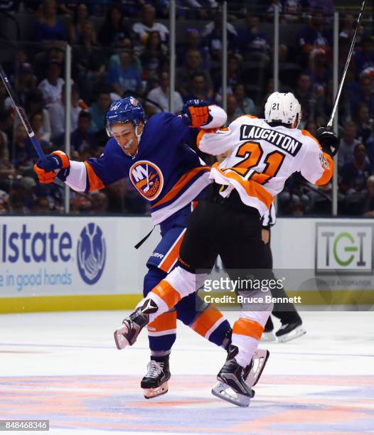 Anders Lee of the New York Islanders and Scott Laughton of the Philadelphia Flyers collide during the first period during a preseason game at the...