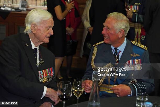Prince Charles, Prince of Wales talks to Battle of Britain veteran Wing Commander Tom Neil during a reception following a service marking the 77th...