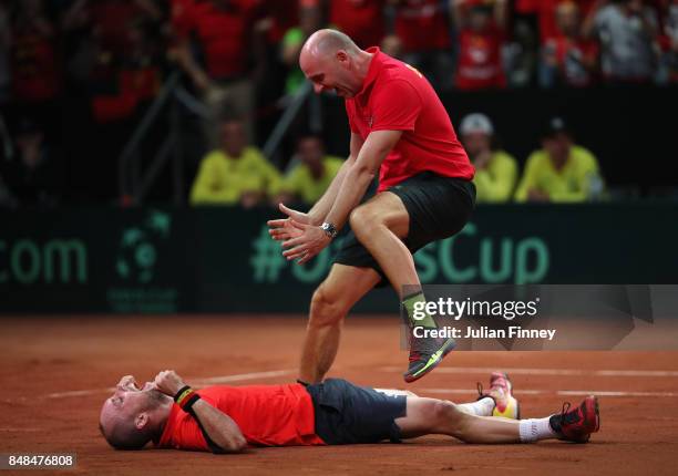 Steve Darcis of Belgium celebrates defeating Jordan Thompson of Australia with Captain, Johan Van Herck of Belgium during day three of the Davis Cup...