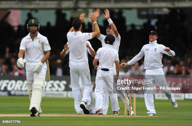 South Africa's Alviro Petersen walks off as England's Steven Finn celebrates his wicket during the Third Investec Test Match at Lord's Cricket...