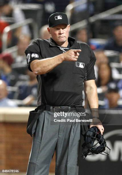 Umpire John Tumpane gestures toward the New York Yankees dugout during an MLB baseball game against the Tampa Bay Rays on September 12, 2017 at...