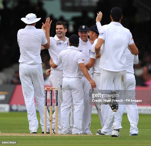 England's James Anderson celebrates with team mates after taking the wicket of South Africa's JP Duminy during the Third Investec Test Match at...