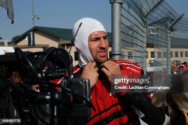 Klay Thompson of the Golden State Warriors NBA team suits up at the track for a ride in a two-seat IndyCar with driver Davey Hamilton on day 3 of the...