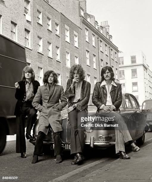 English rock group Led Zeppelin posed on a Jaguar car in a London street in December 1968. Left to right: John Paul Jones, Jimmy Page, Robert Plant...