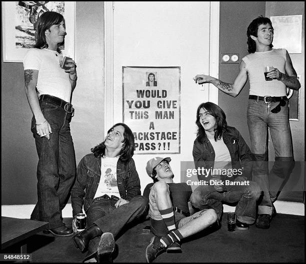 Photo of AC/DC; L-R: Phil Rudd, Mark Evans, Angus Young, Malcolm Young, Bon Scott - posed, group shot at press reception in WEA offices