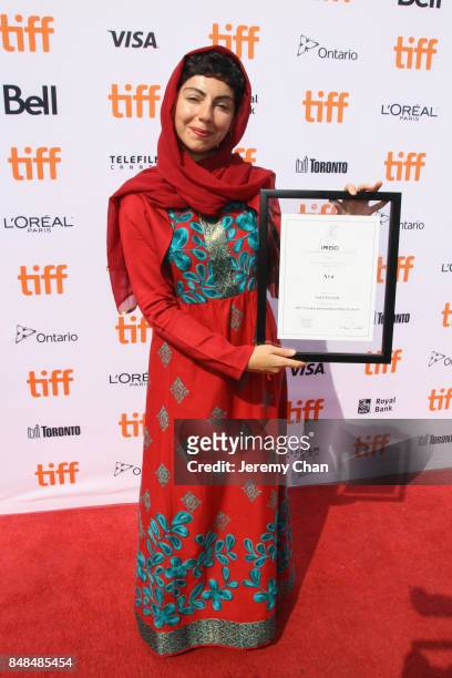 Director Sadaf Foroughi poses after being awarded with the Prize of the International Federation of Film Critics Discovery for 'Ava' at the 2017 TIFF...