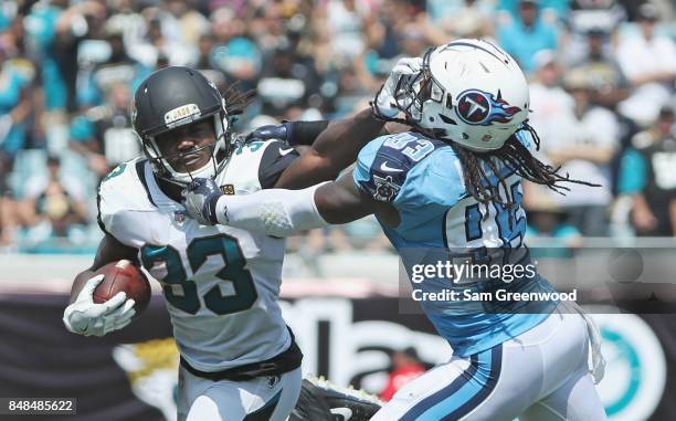 Chris Ivory of the Jacksonville Jaguars fights off the tackle of Eric Walden of the Tennessee Titans during the first half of their game at EverBank...