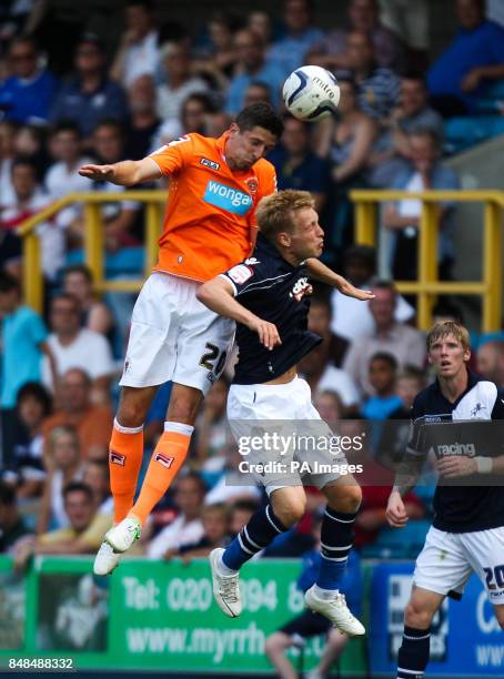 Blackpool's Craig Cathcart battles for possession of the ball in the air with Millwall's Josh Wright during the npower Championship match at The Den,...