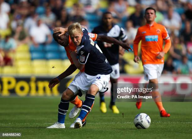 Millwall's Josh Wright battles for possession of the ball with Blackpool's Isaiah Osbourne during the npower Championship match at The Den, London.