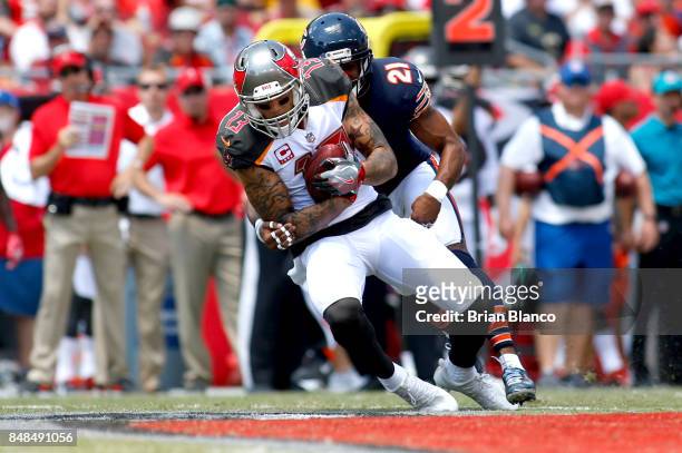 Wide receiver Mike Evans of the Tampa Bay Buccaneers hauls in a pass from quarterback Jameis Winston in front of strong safety Quintin Demps of the...