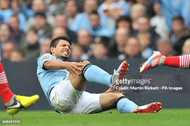 Manchester City's Sergio Aguero holds his knee after a tackle by Southampton's Nathaniel Clyne