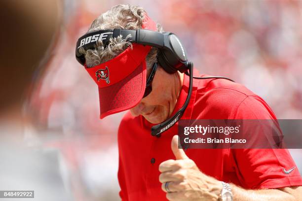 Head coach Dirk Koetter of the Tampa Bay Buccaneers reacts as a 47-yard interception for a touchdown by defensive back Robert McClain was upheld on...
