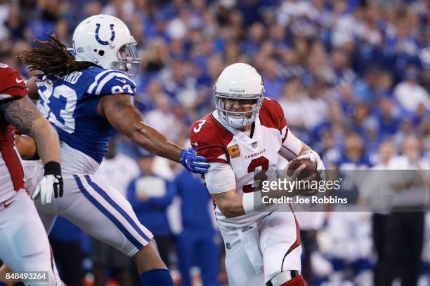 Carson Palmer of the Arizona Cardinals sidesteps Jabaal Sheard of the Indianapolis Colts while trying to pass the ball in the second quarter of a...