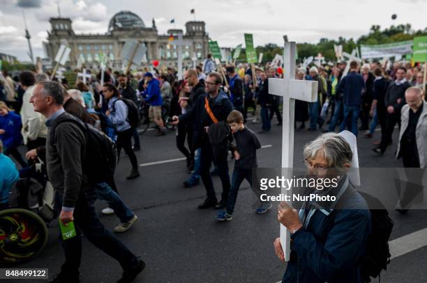 Participants in &quot;The March For Life&quot; are seen carrying crosses as they march through Berlin's Mitte district, on September 16, 2017. In the...