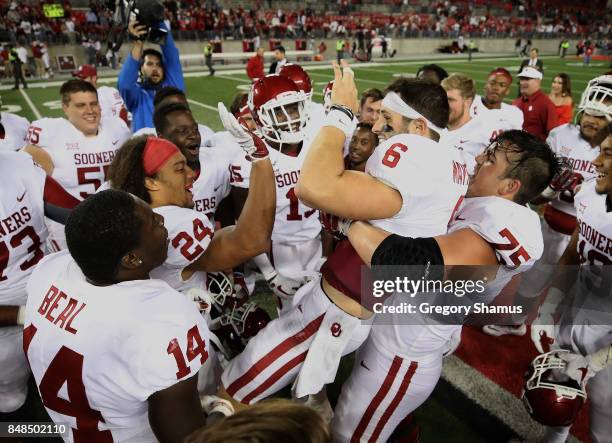 Baker Mayfield of the Oklahoma Sooners celebrates with teammates after defeating the Ohio State Buckeyes 31-16 at Ohio Stadium on September 9, 2017...