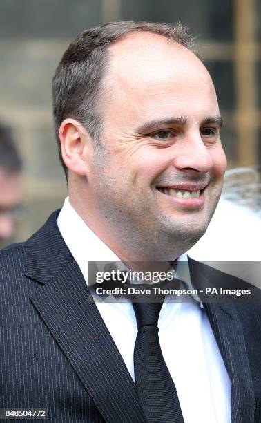 Dan Waddell leaves Pudsey Parish Church in West Yorkshire following the funeral of his father, former darts commentator Sid Waddell.