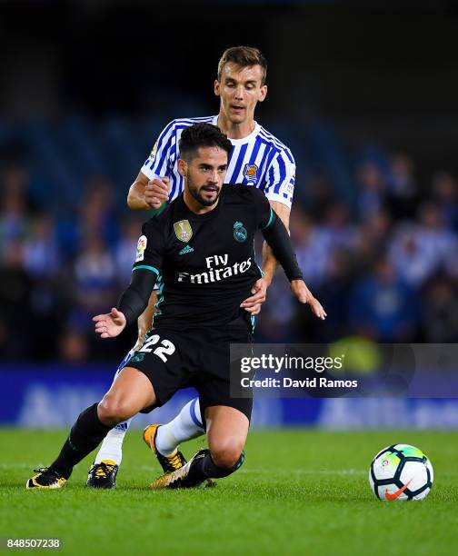 Isco Alarcon of Real Madrid CF competes for the ball with Diego Llorente of Real Sociedad de Futbol during the La Liga match between Real Sociedad...