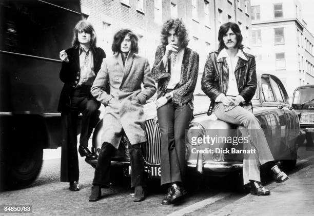 Group portrait of Led Zeppelin leaning against a Jaguar car in a London street, December 1968. L-R: John Paul Jones, Jimmy Page, Robert Plant, John...