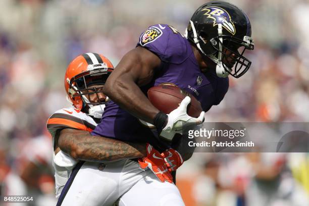 Cornerback Jamar Taylor of the Cleveland Browns tackles free safety Eric Weddle of the Baltimore Ravens in the third quarter at M&T Bank Stadium on...